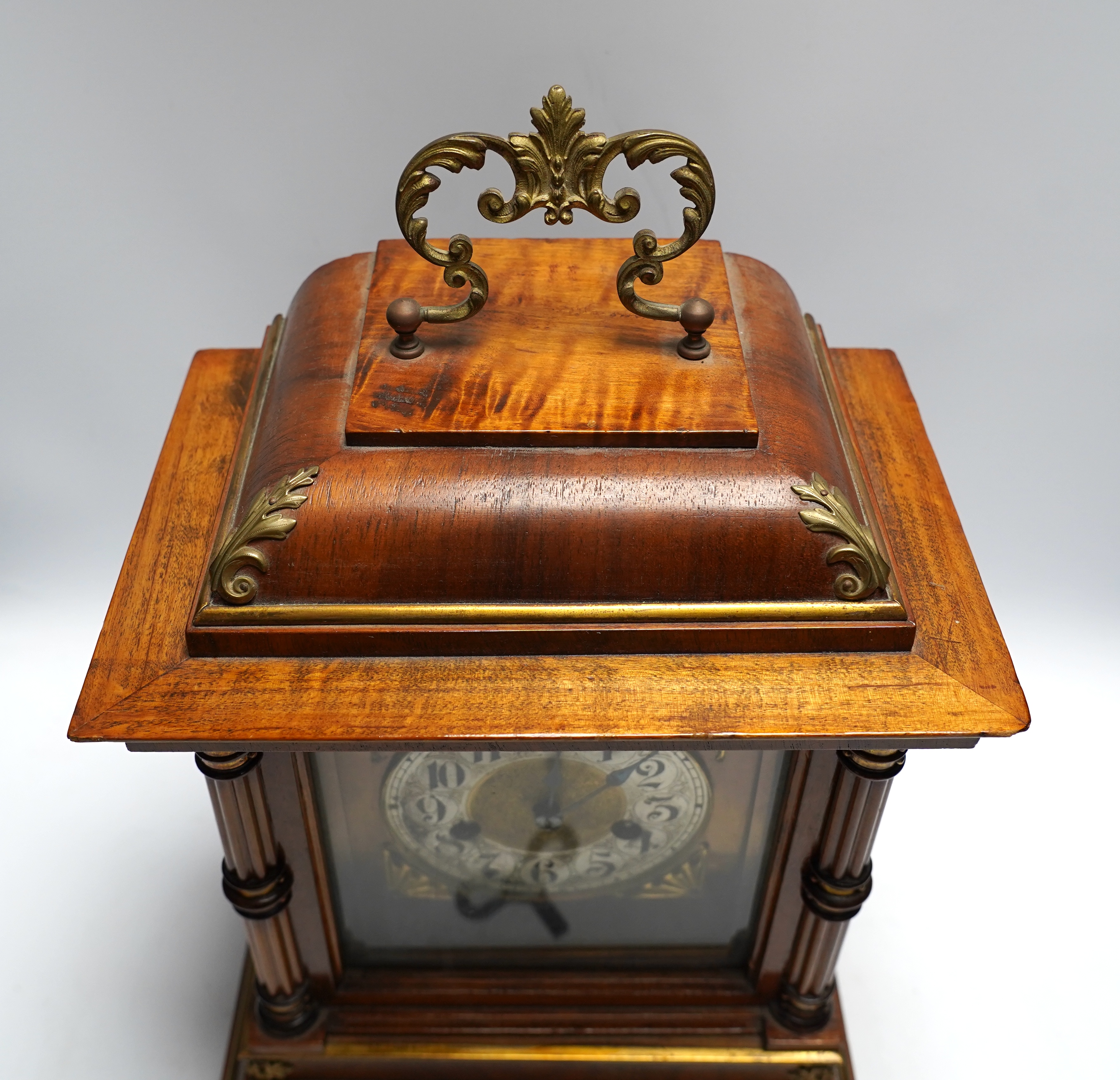 A Black Forest mantel clock with an HAC, Wurttemberg movement, striking on a coiled gong, 35cm high together with an early 20th century inlaid mahogany mantel clock